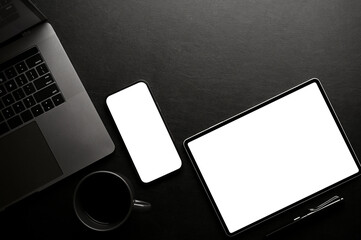 Fototapeta Stylish black office desk workspace top view, with smartphone and tablet mockup obraz