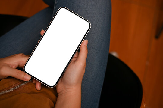 Overhead, Female using smartphone to chat with someone. Phone white screen mockup