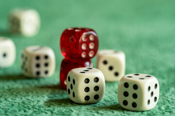 Close up photo of red and white dices on green background. Gambling and luck concept.