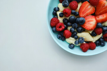Healthy breakfast in bowls of cottage cheese with fresh raspberry blueberries and strawberries. Health and diet concept
