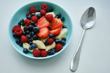 Healthy breakfast in bowls of cottage cheese with fresh raspberry blueberries and strawberries. Health and diet concept
