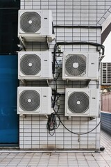 Group of outer air conditioners hanging on wall of residential building. Maintenance house facilities. Reliability and durability air conditioners for hot climate countries.Climate technology.