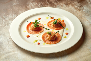 Orange ravioli filled with sauce. Close-up, selective focus