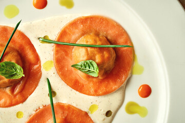 Orange ravioli filled with sauce. Close-up, selective focus
