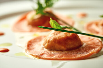 Orange ravioli filled with sauce. Close-up, selective focus