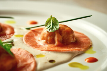 Orange ravioli filled with sauce. Close-up, selective focus