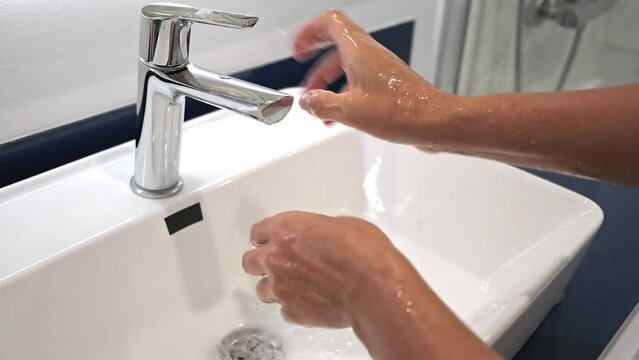 Washing hands rubbing with soap voman for corona virus prevention, hygiene to stop spreading covid omicron