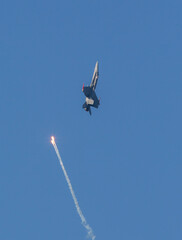 Warfare concept image, a missile almost hitting a modern jet fighter.