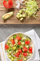 Salad of fresh vegetables and herbs with quinoa seeds and olive oil