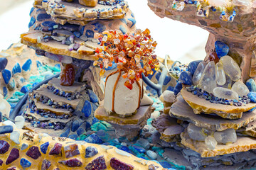 Bright colorful gem tree with lapis lazuli and other gemstones and crystals in decorative...