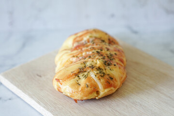 Sausage buns bread. Soft baked bun (dough) stuffed with sausage for fast food breakfast or coffee break. Sausage roll, (hot dog).
With mayo, tomato sauce, mozarella cheese and parsley topping
