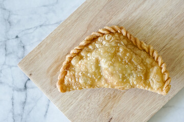 Cornish pasty filled with chicken and potato. Pastry minced pie or Pastel asian style cuisine. Homemade flaky pasty with mince meat filling - obrazy, fototapety, plakaty