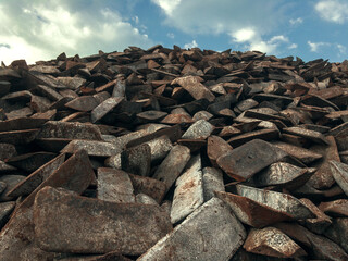 Cast-iron piglets in a warehouse against a blue sky. The form of cast iron: ingots, ingots solid...