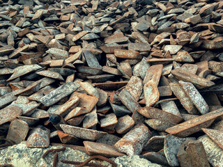 Ingots of cast iron stored in the warehouse. Cast iron obtained by melting iron ore, formed into ingots of impure iron for further processing stages.