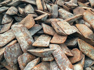 Ingots of cast iron stored in the warehouse. The form of cast iron: ingots, ingots solid condition. Transfer cast iron is cast iron used for further processing into steel.