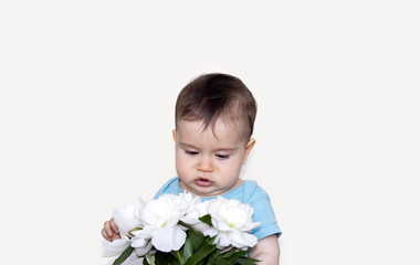 Obraz na płótnie Canvas white peonies bouquet and little cute baby boy smell the flowers.funny face toddler expression,emotion.flowers delivery,buy concept,shop store.isolated on beige light background.beautiful peony flower