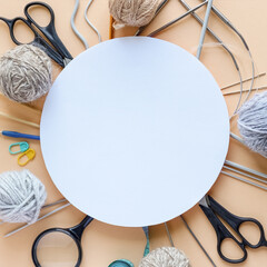 Knitting accessories, knitting hook, knitting needles, scissors, magnifying glass, needles, centimeter and balls of thread with space for text. Flat lay