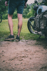 a retro motorcycle tourer with muddy feet