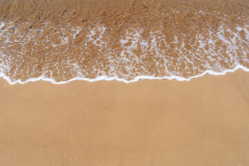 Top view photo of beach sand and ripples with bubbles. 