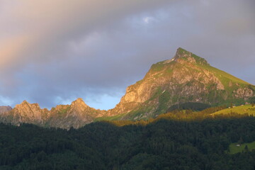 A majestic mountain called Fronalpstock in the Glarus Alps, illuminated by the evening sun