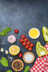 Food background from vegetable, spices, herb on black table.