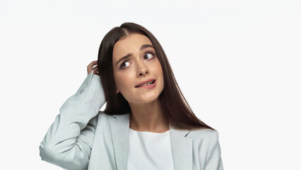 puzzled businesswoman in grey blazer touching head isolated on white.