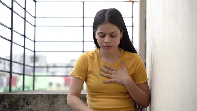 Asthmatic patient catching inhaler having an asthma attack. Young woman having asthma, chronic obstructive pulmonary disease