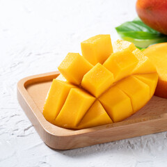 Mango background design concept. Top view Diced fresh mango fruit on white table.