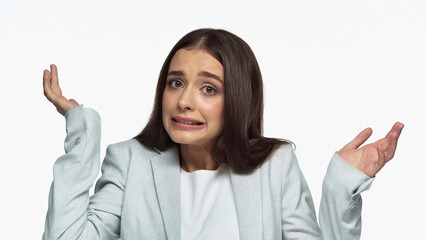 confused businesswoman in grey blazer showing shrug gesture isolated on white.