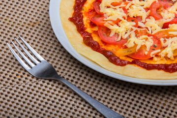Tomato pizza topped with melted cheese
