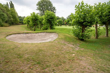 golf course with grass and clouds in the sky