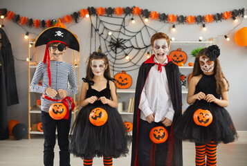 Group of children in different Halloween costumes. Bunch of kids dressed up as spooky characters...