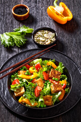 tofu salad with greens and vegetables in bowl