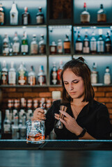 young woman bartender Making Cocktail in bar