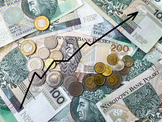 Background of Polish banknotes and coins in close-up with a growth chart. Background of 100 zloty banknotes