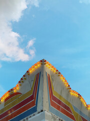 detail of amusement park sign against blue sky