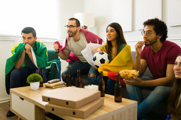 Tense friends supporting their favorite sports team