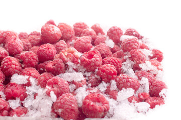 Ripe juicy frozen raspberries on a white background. Freezing berries to preserve beneficial...