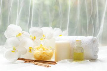 Fototapeta na wymiar Thai Spa Treatments aroma therapy salt and nature green sugar scrub massage with orchid flower on wooden white with candle. Thailand. Healthy Concept