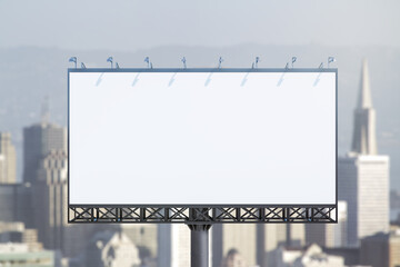 Obraz premium Blank white horizontal billboard on city buildings background at daytime, front view. Mockup, advertising concept