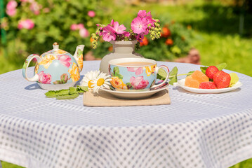 Tea drinking at the garden table in the fresh air for a pleasant pastime.