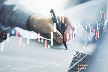 Naklejka premium Abstract creative financial graph with world map and with hand writing in notebook on background with laptop, forex and investment concept. Multiexposure