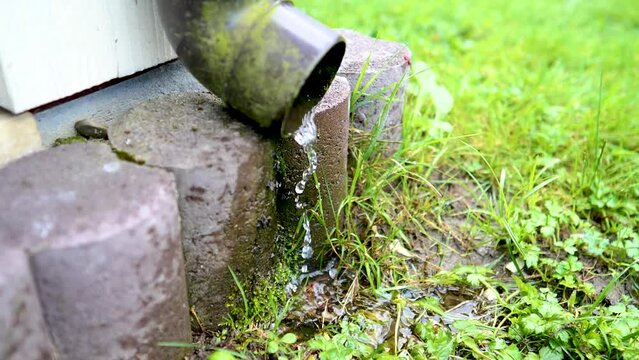 It's raining. water flows from the gutter