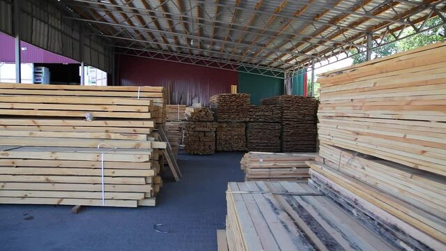 Wood warehouse. Sliced wooden boards are stored in a trading warehouse. Goods and materials arranged on a rack in warehouse.