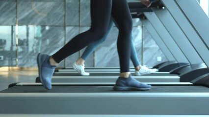 woman exercising on treadmill, Young athletic woman legs jogging on treadmill in hotel sport club slow motion - Powered by Adobe