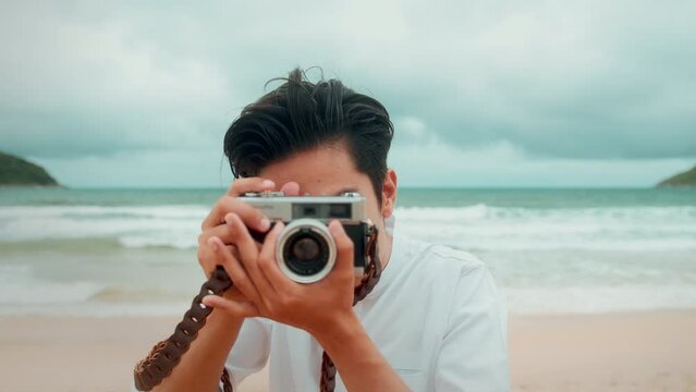 A man is taking photo on the beach on holidays, travel, romantic, wedding concept