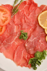 Carpaccio dish of thinly sliced pieces (slices) raw beef tenderloin 
