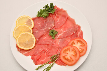 Carpaccio dish of thinly sliced pieces (slices) raw beef tenderloin 