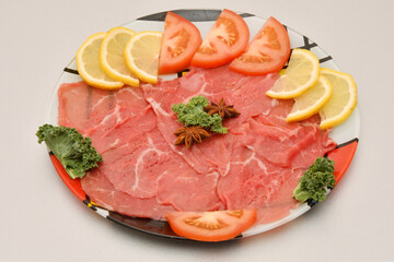 Carpaccio dish of thinly sliced pieces (slices) raw beef tenderloin 