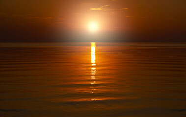 Beautiful orange sunset is reflected in the sea.